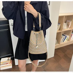 Beige litchi pattern studded bucket bag, stylish punk style crossbody and shoulder handbag.