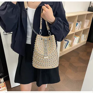 Detail view of the stylish rhinestone studded bucket bag showing texture and hardware.