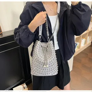 Grey studded bucket bag with rhinestones, leather shoulder bag with chain strap and pearls.