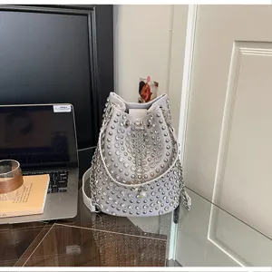 Chic rivet studded bucket bag with rhinestones and chain strap for women punk fashion daily.