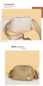 Genuine leather shoulder messenger bag for women with wide strap and chic metallic pendant details.