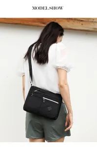 Classic black nylon crossbody bag for women, multi-pocket design, casual everyday wear.