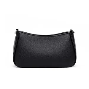 Close up of black leather shoulder bag detail, minimal textured handbag strap and hardware.