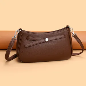 Brown leather crossbody shoulder bag with stylish bow accent and silver hardware for daily use