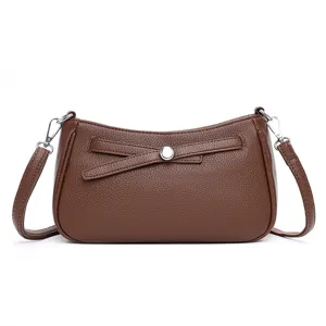 Classic brown leather crossbody bag with chic metal accent, versatile casual shoulder purse for women.