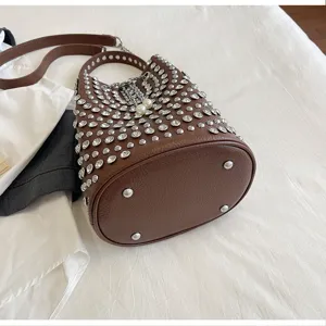 Brown rhinestone studded bucket bag with shoulder strap and large capacity for daily use.