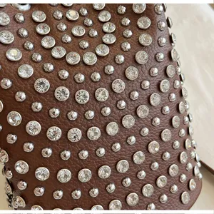 Brown lychee leather rhinestone studded bucket bag detail shot showcasing punk crystal texture