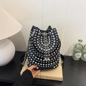 Black leather bucket bag featuring sparkling rhinestones and silver studs, chain drawstring closure.