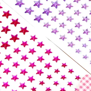 Close-up detail of sparkling acrylic star rhinestone stickers in pink and purple colors.