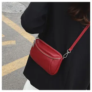 Red leather mini crossbody shoulder bag detail view with double zippers and metal hardware.
