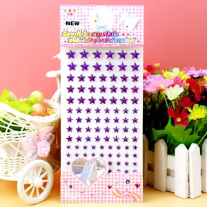 Detail shot of purple acrylic star rhinestone crystal stickers with card backing for craft and party decor.