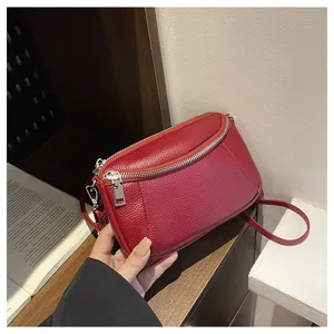 Genuine leather mini crossbody shoulder bag for women with double zippers and compact red design.
