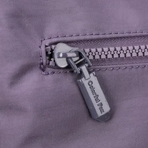 Close-up detail shot of the durable purple fabric bag zipper pull with clear texture and fine craft.
