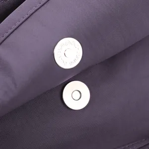 Close-up detail shot of the purple shoulder bag showing its metal magnetic clasp and fabric.