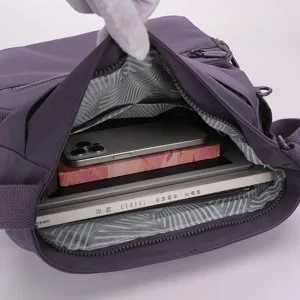 Stylish purple nylon crossbody bag with spacious interior compartments for daily essentials.