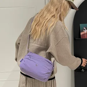 Trendy women's casual multi-layer crossbody canvas shoulder bag for daily use.