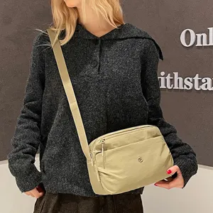 Casual multi-layer canvas crossbody bag for women, lightweight everyday shoulder bag.