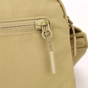 Khaki canvas crossbody bag detail shot, featuring durable ripstop fabric and custom zipper pull.