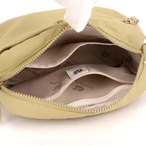 Multi-layer nylon crossbody bag interior detail showing spacious compartments and zipper pockets.