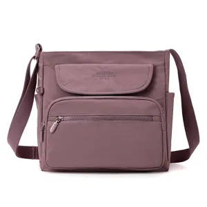 Stylish purple fabric crossbody shoulder bag with multi-pockets front view display