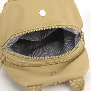Vista dettagliata dello zaino in nylon cachi con cerniera liscia e fodera a righe.