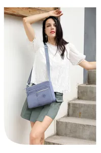 Close up view of the multi-pocket nylon crossbody bag showcasing sturdy zipper and fabric.