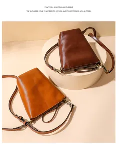 Detailed view of women's minimalist leather shoulder crossbody bag in stylish brown colors.
