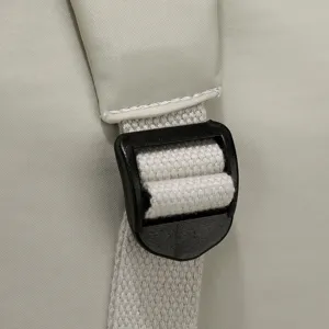 Close up detail of laptop bag adjustable strap and sturdy plastic buckle. Durable design.