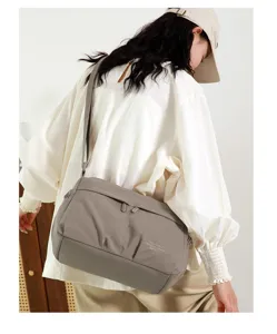 Detail view of women grey nylon crossbody bag, casual daily shoulder bag, chic style.