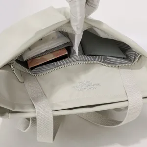 Detailed view of the lightweight waterproof nylon laptop tote bag interior compartments and lining.