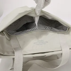 Lightweight waterproof nylon laptop handbag detail shot showing interior lining and zipper pocket.