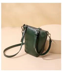 Dark green leather crossbody shoulder bag for women, minimalist daily design with metal strap.
