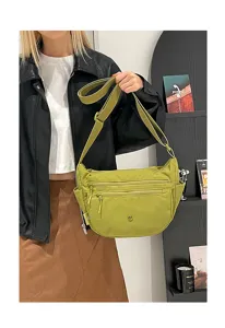 Detail view of casual nylon crossbody bag with multi-zip pockets in light green for daily use.