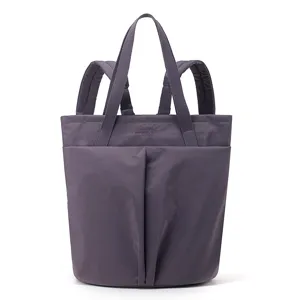 Close-up detail of the purple waterproof nylon tote backpack, showing durable straps and pockets.