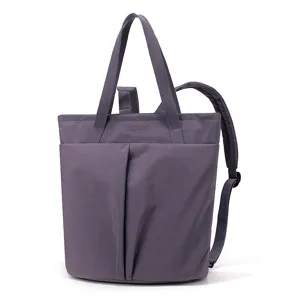 Water-resistant nylon laptop tote bag and convertible backpack in purple for women work daily.