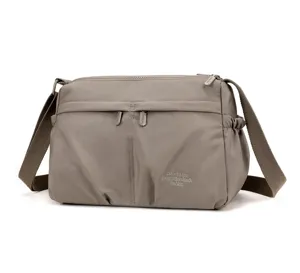 Detail shot of casual women nylon shoulder bag with multiple zippered pockets and wide strap.