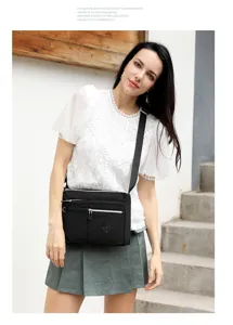 Detailed view of women's nylon crossbody bag with multiple zipper pockets for daily use.