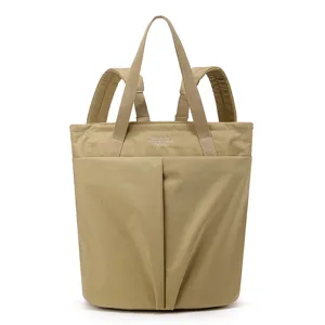 Detailed view of the waterproof nylon laptop backpack and versatile tote bag in khaki finish.