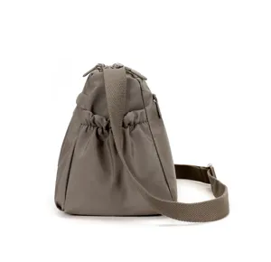 Detail shot of women nylon crossbody bag, casual shoulder bag with strap and side pocket design.