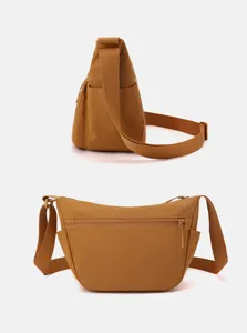 Side and front details of casual nylon crossbody bag with multi-pocket and strap.
