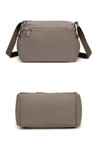 Gray nylon crossbody bag detail view featuring zipper pocket and bottom structure.