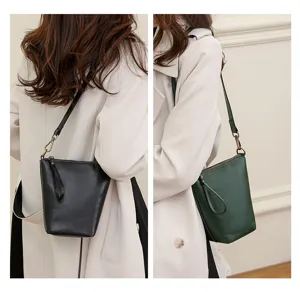 Minimalist leather shoulder bag detail showing black and dark green color options.