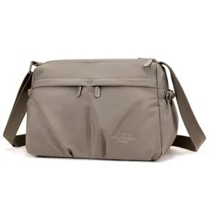 Nylon crossbody bag detail, features multi zippers and adjustable strap for daily use.