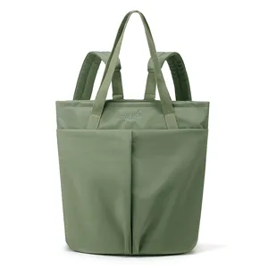 Green nylon convertible tote backpack detail showing front pockets and dual carry straps construction.