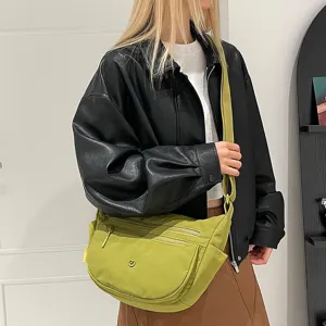 Detail view of the casual nylon crossbody bag featuring multi-compartment design and zipper pockets.