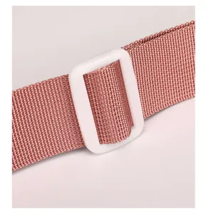 Close-up detail of durable nylon shoulder strap with adjustable white buckle for stylish bags.