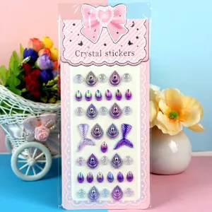 Detailed close-up of colorful acrylic crystal stickers featuring mermaid tail and heart shapes.