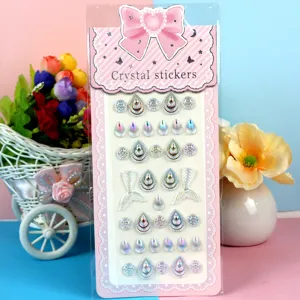 Detailed view of colorful crystal stickers featuring teardrop and mermaid tail designs.
