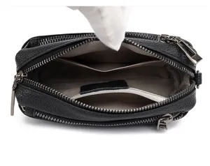 Black genuine leather crossbody bag interior detail showing multiple compartments and lining.