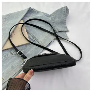 Black leather mini crossbody bag featuring double zippers and slim strap for women daily use.